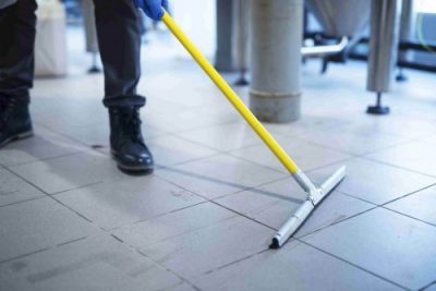 a man cleaning a Low-maintenance metallic concrete floor in Prairieville, LA