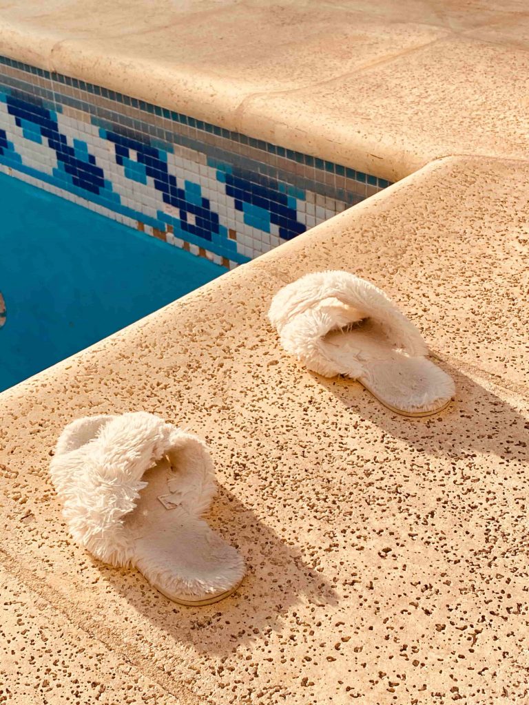 pair of slipper on pool deck
