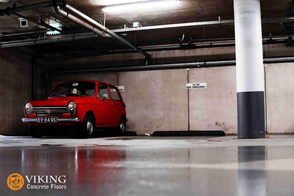 a red car in garage with nice flooring