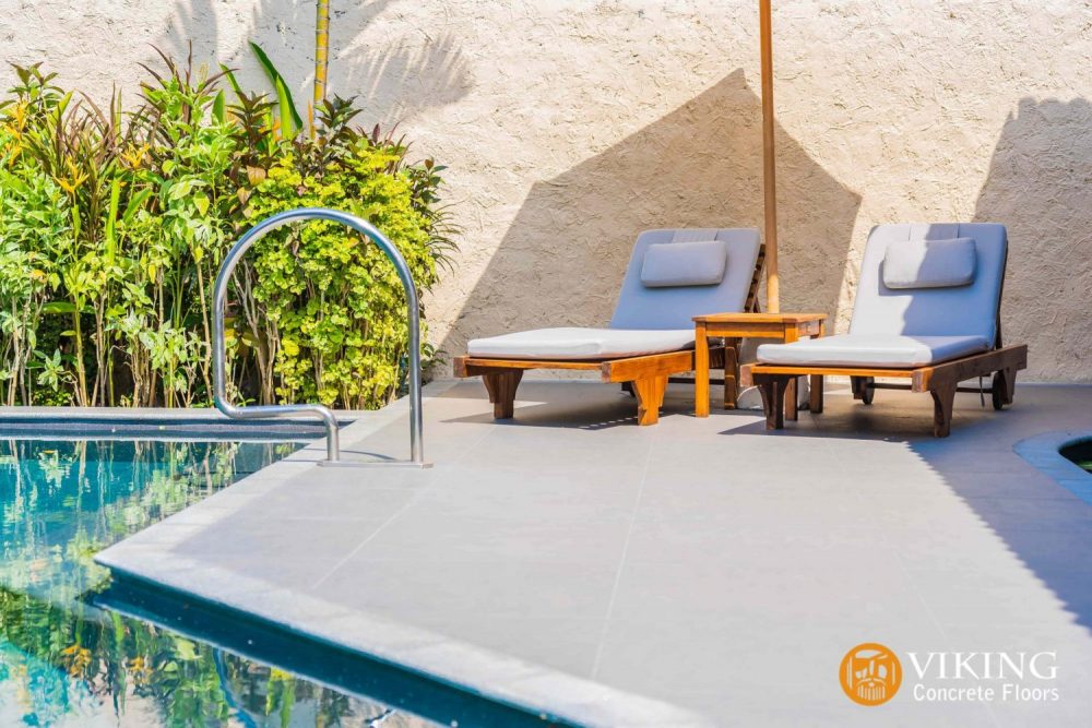 two chairs near pool on cool touch deck flooring