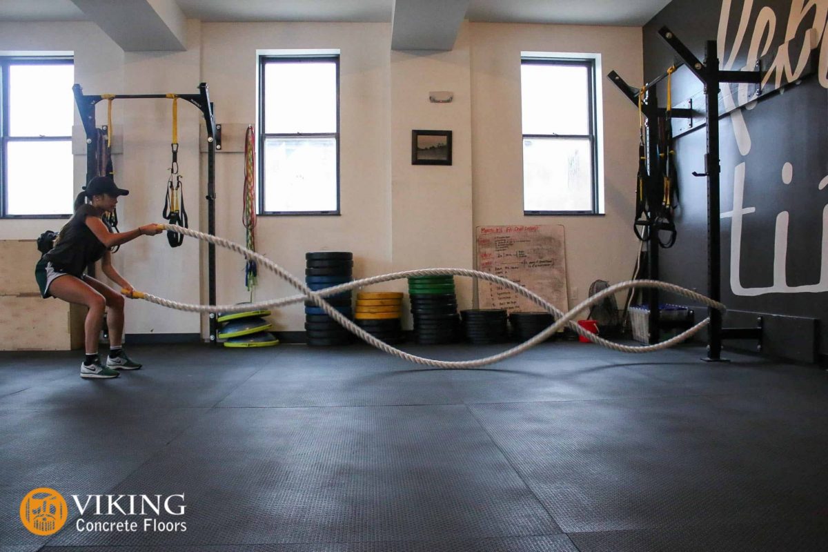 a woman working out in garage home gym by flooring in Prairieville, LA 
