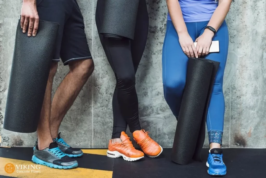 Gym members on holding mats in gym with concrete floors in Prairieville, LA